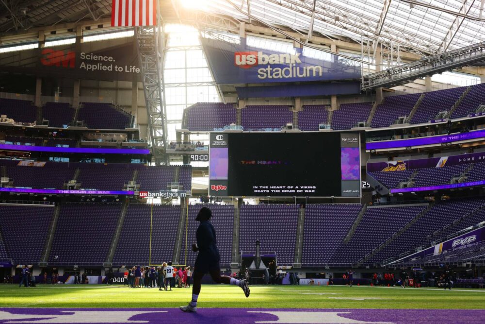 Bears defensive end Kingsley Jonathan sprints onto the field for warmups before a game against the Vikings on Oct. 9, 2022, at U.S. Bank Stadium in Minneapolis.