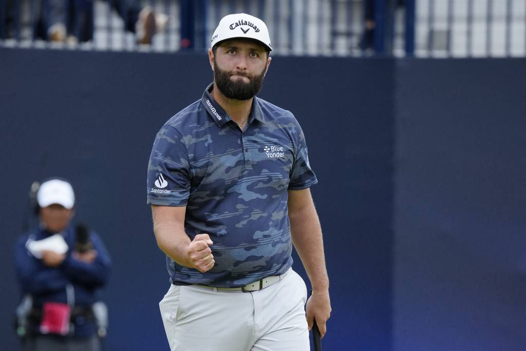 Jon Rahm pumps his fist after making a birdie on No. 18th during Round 3 of the British on Saturday at the Royal Liverpool Golf Club in Hoylake, England. Rahm had seven birdies over the last 10 holes and set the Open record at Royal Liverpool with a 63. He still trails leader Brian Harman by six shots.