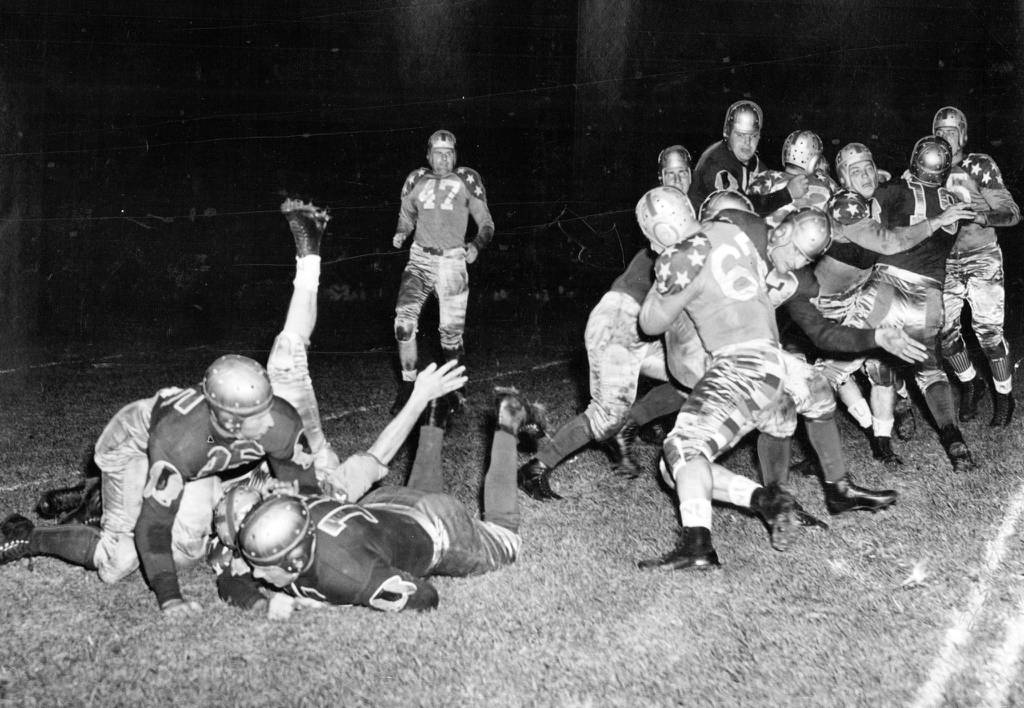Max Krause, full back of the Washington Redskins, crashes over the goal line from the 2 yard line in a battle with the College All-Americans on Aug. 31, 1938. The game, witnessed by 74,250, was won by the All-Stars, 28 to 16.