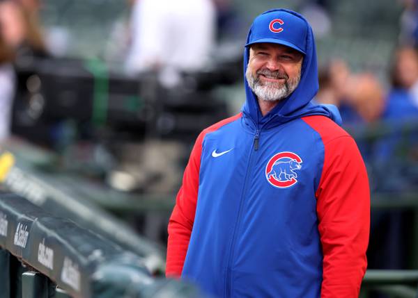 Cubs manager David Ross has a laugh in the dugout before a game against the Pirates on June 15, 2023, at Wrigley Field.