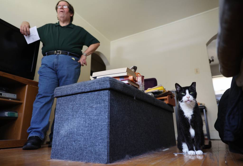Gordon Dymowski talks about the eviction notice in the apartment where he has lived for the past six years as his cat, Frankie, sits nearby in the 10300 block of South Walden Parkway on July 19, 2023, in Chicago.