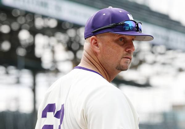 Northwestern baseball coach Jim Foster heads back to the dugout for a game against Notre Dame at Wrigley Field on May 16, 2023.
