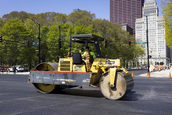 A worker resurfaces Columbus Drive along Grant Park in advance of the NASCAR Chicago Street Race race on May 3, 2023.