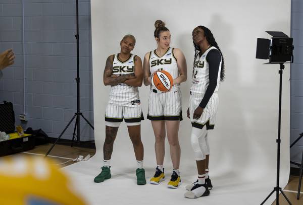 Sky players Courtney Williams, Marina Mabrey and Kahleah Copper take pictures together on May 10, 2023, at media day.