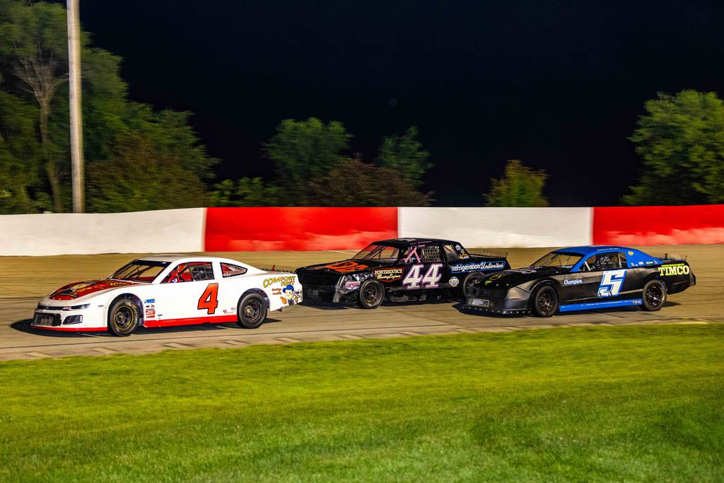 Matt Chester (4), Renee Farren (44) and Cameron Preisler (5) run together during a street stocks race at Grundy County Speedway on Friday, July 21, 2023.