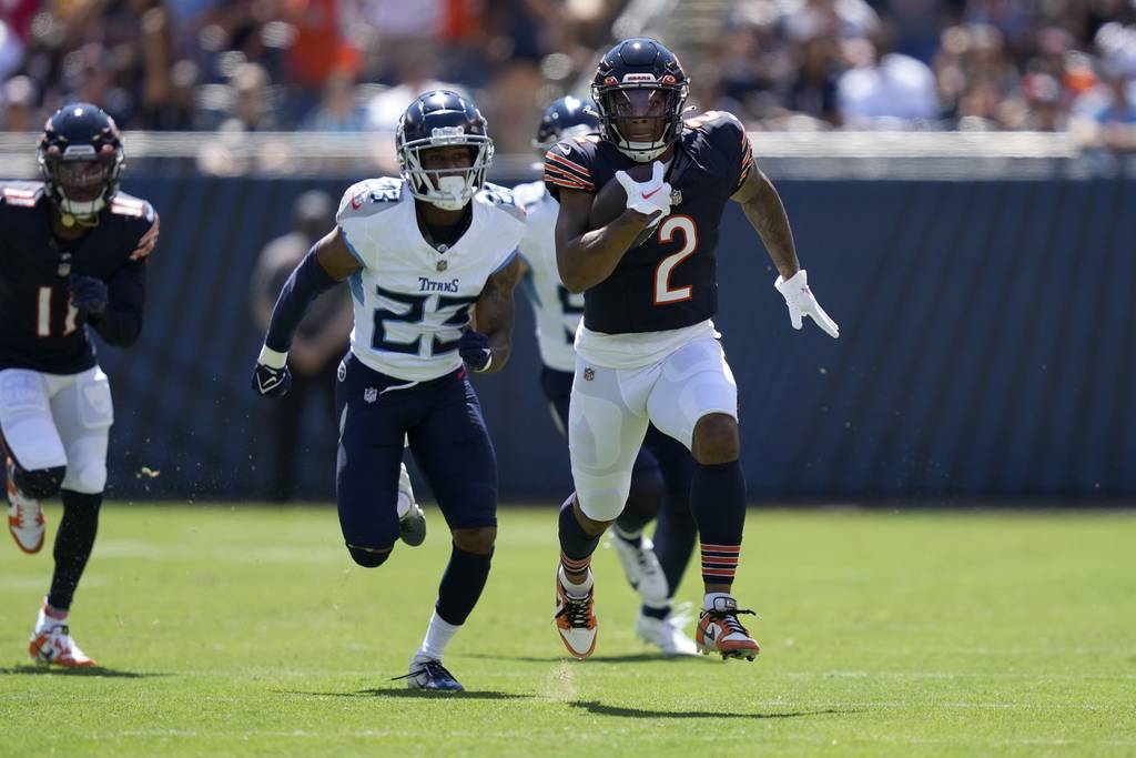 Bears wide receiver DJ Moore runs after a catch for a touchdown against the Titans during the first half of on Aug. 12, 2023.