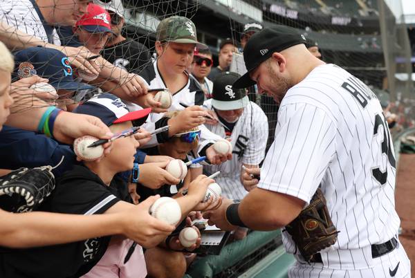White Sox third baseman Jake Burger signs autographs before a game against the Cardinals at Guaranteed Rate Field on July 8, 2023.