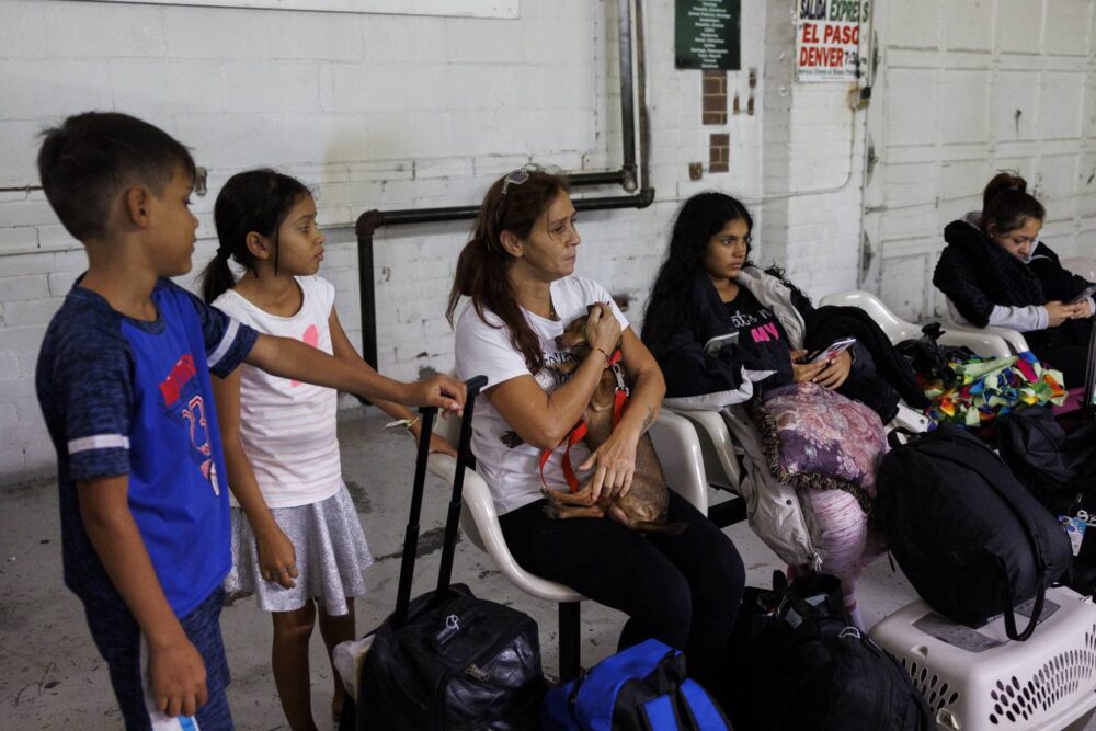 Esperanza, center, holds onto Milo the dog after their 11-hour bus ride from El Paso, Texas, landed them in Denver. Surrounding Esperanza are Pedro, from left, Yuledy and Yolexi on July 14, 2023.