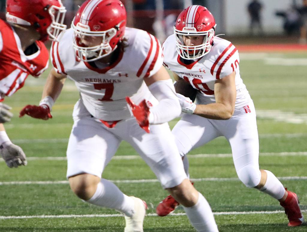 Naperville Central’s Jude Sutherland, right, looks for room to run during a game against Hinsdale Central in Hinsdale on Friday, Aug. 25, 2023.