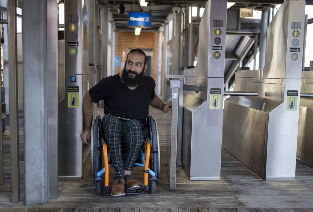 Atta Zahedi goes through the gates at the CTA Brown Line on Aug. 15, 2023. Zahedi is going through the process of applying for a reduced-fare permit.