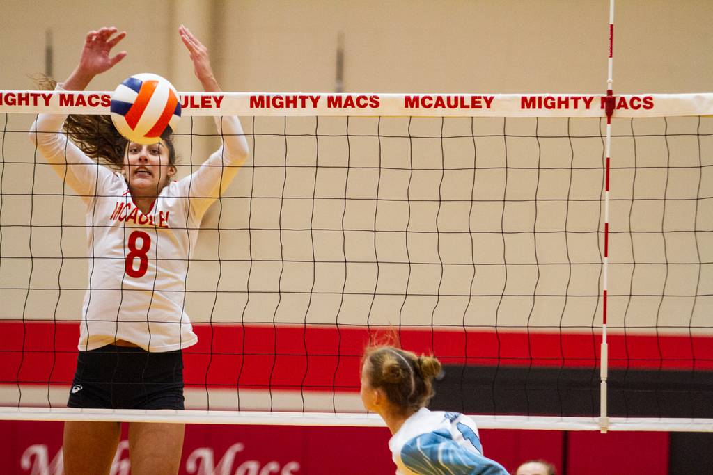Mother McAuley's Ellie White stuffs a block against Joliet Catholic during a nonconference match in Chicago on Tuesday, Aug. 23, 2022.