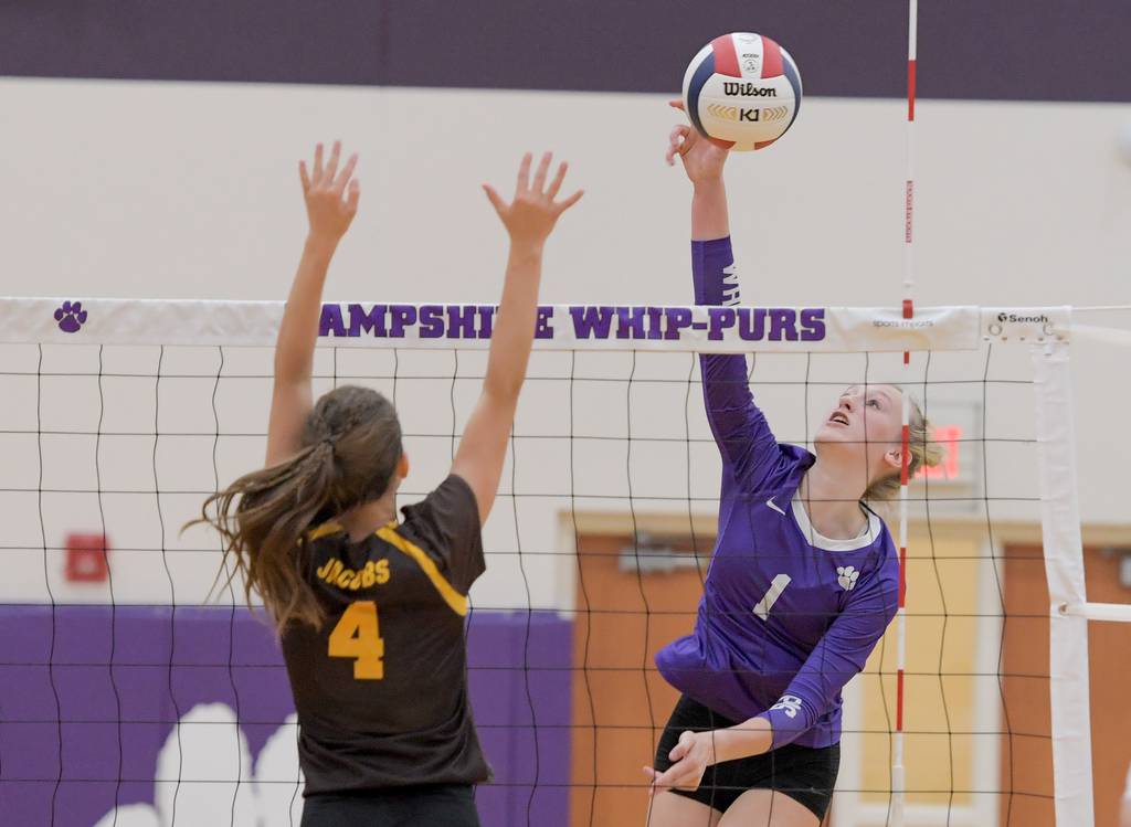 Hampshire's Elizabeth King (1) hits the ball past Jacobs' Mia Koltuniuk (4) in the second game of a Fox Valley Conference match in Hampshire on Thursday, Aug. 24, 2023.