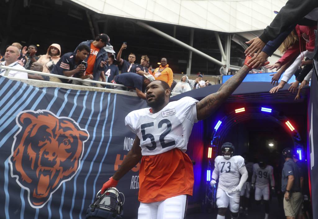 Bears defensive lineman Terrell Lewis high-fives fans while walking out of the tunnel during Family Fest on Aug. 6 at Soldier Field. 