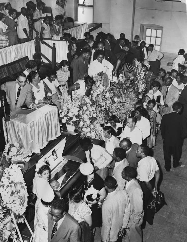 The crowd files past the open casket of Emmett Till inside Roberts Temple Church of God in Christ to pay their respects at his funeral on Sept. 3, 1955. 