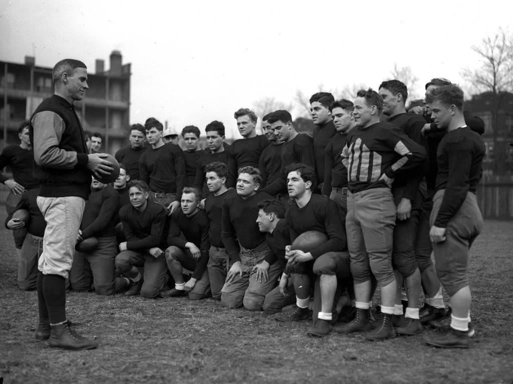 Clark Shaughnessy, left, was the University of Chicago's last football coach before the program was shut down in 1939. Shaughnessy, shown here with the squad in 1933, pioneered the offensive innovation of the T-formation.