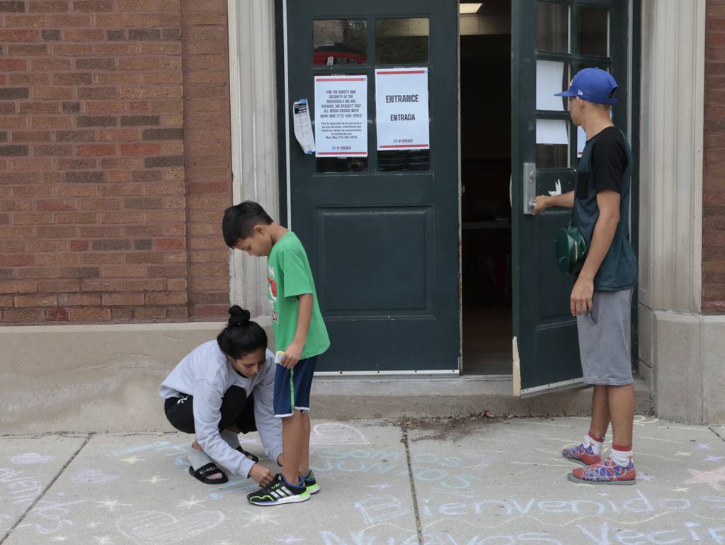 Migrants outside of the Broadway Armory after arriving on Aug. 1, 2023. Community residents have both protested and welcomed the migrants.  