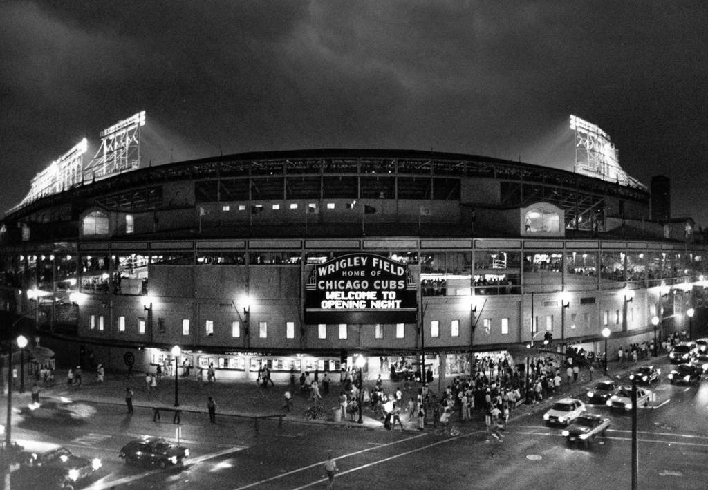 Looking a little like something from a galaxy far, far away, Wrigley Field is bathed in light for its first night baseball game Monday night, as the traffic hurries by on Clark and Addison on Aug. 8, 1988, in Chicago. 