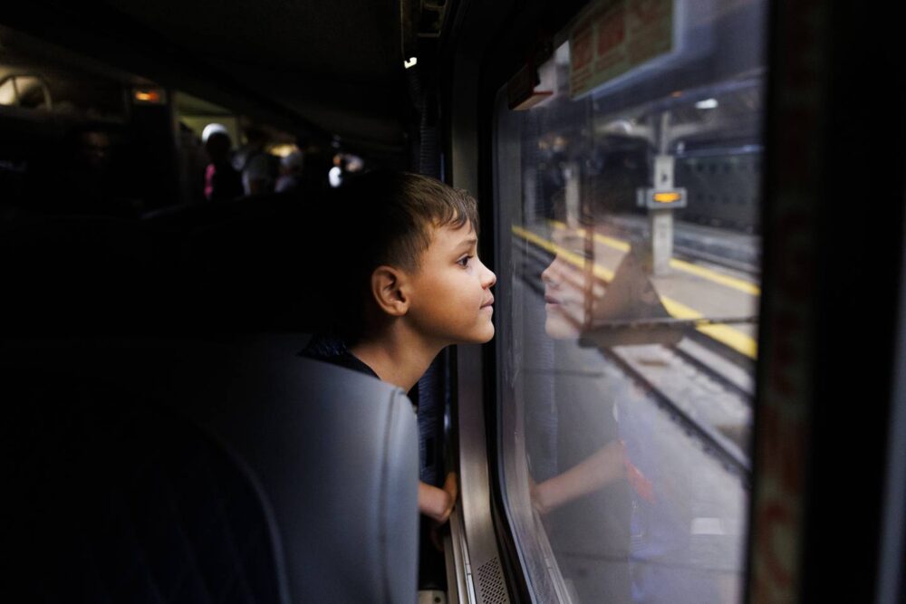 Pedro looks out the window at Union Station after riding a train for 18 hours with his family from Denver to Chicago on July 15, 2023, in Chicago. “My dad is there, and he says on the phone that there are many squirrels there,” said Yuledy.