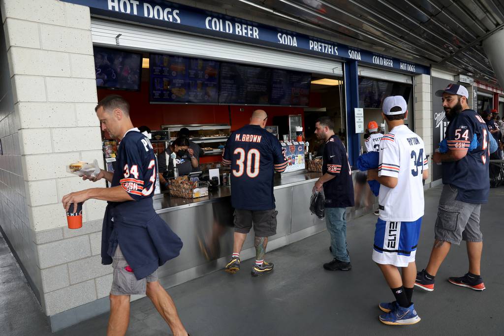 Fans visit a concession stand prior to a game between the Chicago Bears and the Detroit Lions at Soldier Field on Oct. 3, 2021.