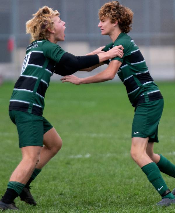 Illiana Christian’s Chase Poortinga, left, and Nolan Flipse celebrate after Flipse scored on a penalty kick during the Class 1A Westview Regional final against Westview in Topeka on Saturday, Oct. 16, 2021.