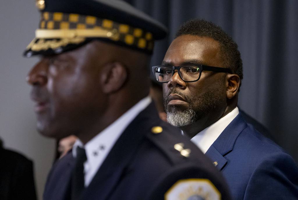 Mayor Brandon Johnson listens as new Chicago police Superintendent Larry Snelling speaks at City Hall on Aug. 14, 2023.
