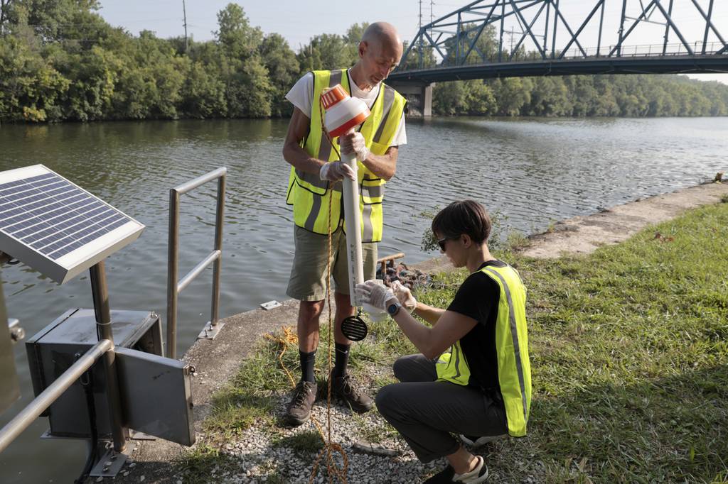 Alaina Harkiness, Current executive director, and Dale Landmann, Current community sampling coordinator, collect water samples at the Cal-Sag Channel testing site in Blue Island, Aug. 24, 2023. 