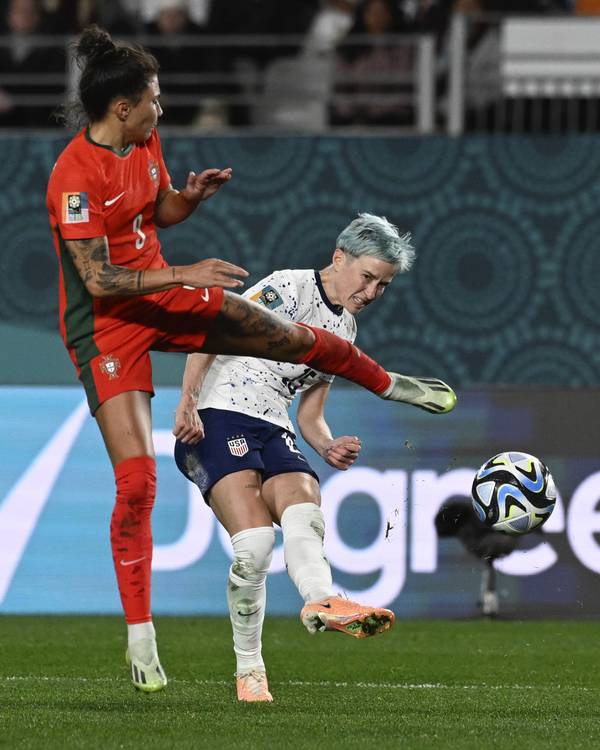 United States' Megan Rapinoe, right, kicks the ball past Portugal's Joana Marchao during a World Cup match on Aug. 1, 2023.
