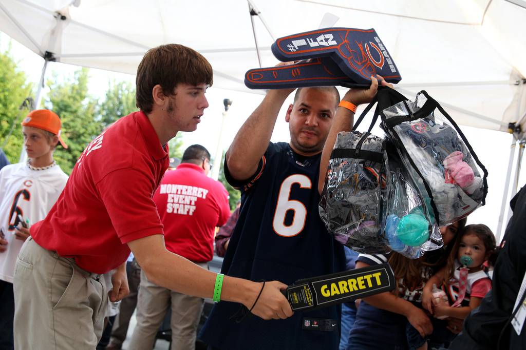 Jorge Vega, of Chicago's Portage Park neighborhood, holds clear plastic bags up as he goes through security measures while entering Soldier Field for a Bears preseason game against the Chargers in 2013.