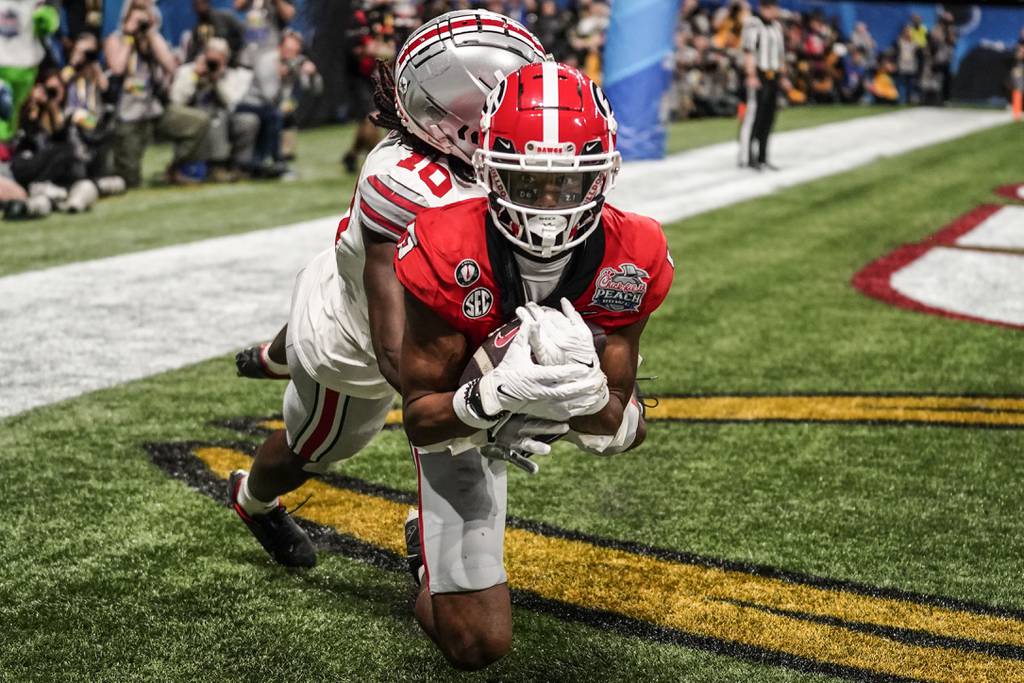 Georgia wide receiver Adonai Mitchell makes a touchdown catch against Ohio State cornerback Denzel Burke during the second half of the Peach Bowl on Dec. 31, 2022.