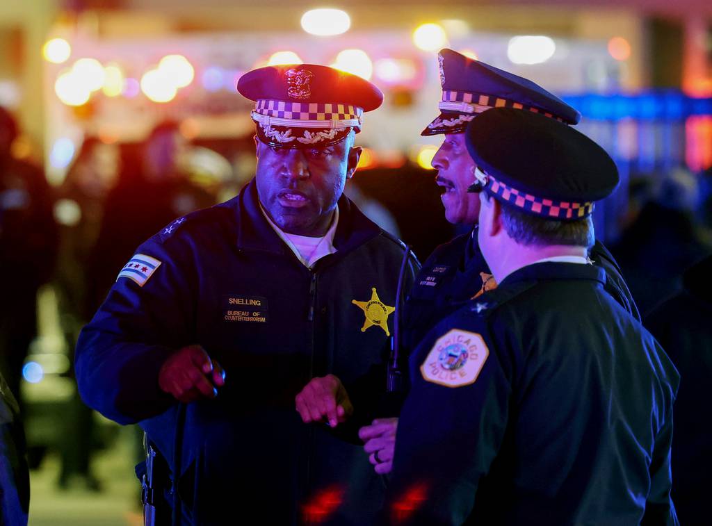 Chief of the Bureau of Counterterrorism, Larry Snelling, left, talks with police supervisors after an incident on March 1, 2023, in Chicago.