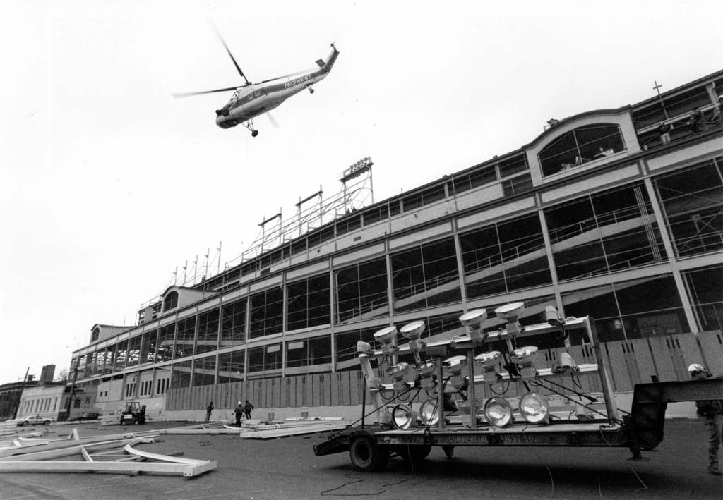 A helicopter lifts lighting equipment to the top of Wrigley Field on April 26, 1988.