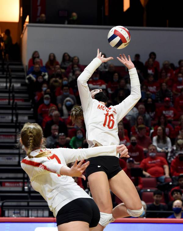 Mother McAuley's Keira Ohse (17) runs a fake as Caroline Macander (16) sets the ball to the opposite side of the court against Metea Valley during the Class 4A state championship match at Illinois State's Redbird Arena in Normal on Saturday, Nov. 13, 2021.