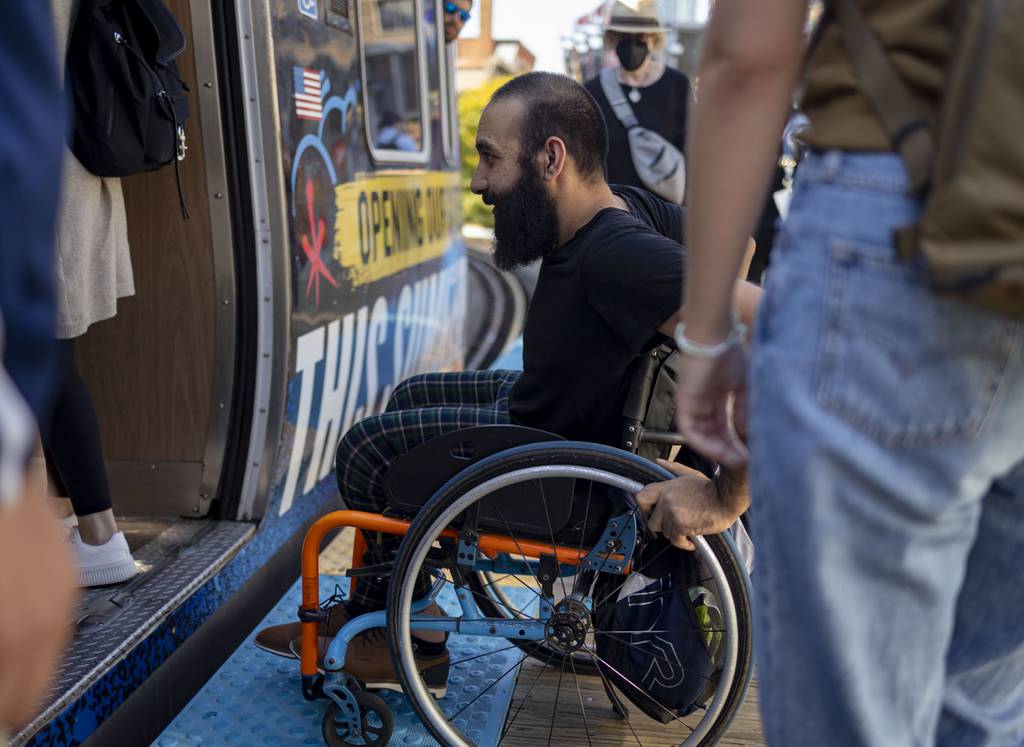 Atta Zahedi boards a CTA Brown Line train on Aug. 15, 2023.