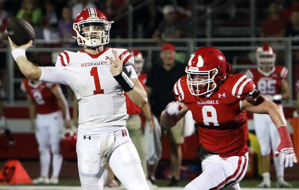 Naperville Central quarterback Jack Cook (1) throws a pass during a game against Hinsdale Central in Hinsdale on Friday, Aug. 25, 2023.