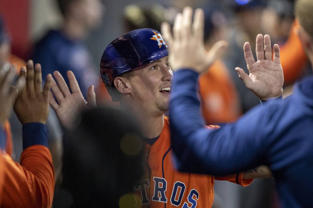 Astros catcher Korey Lee is congratulated after scoring during the 10th inning of a game against the Angels on July 14, 2022, in Anaheim, Calif.