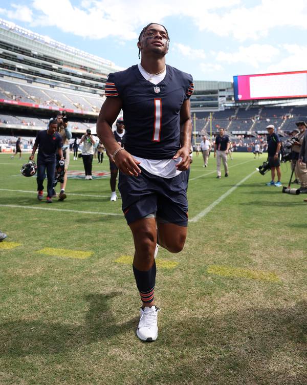 Bears quarterback Justin Fields jogs off the field after a 23-17 win over the Titans in the preseason game opener at Soldier Field on Aug. 12, 2023.