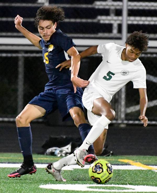 Round Lake’s Oscar Martinez, left, challenges Grayslake Central’s Lafuntae Floyd for the ball during a game in Round Lake on Thursday, Oct. 7, 2021.