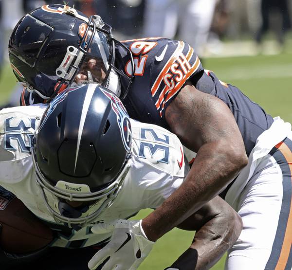 Chicago Bears cornerback Tyrique Stevenson tackles Tennessee Titans running back Tyjae Spears in the first quarter of a preseason game at Soldier Field on Aug. 12, 2023.
