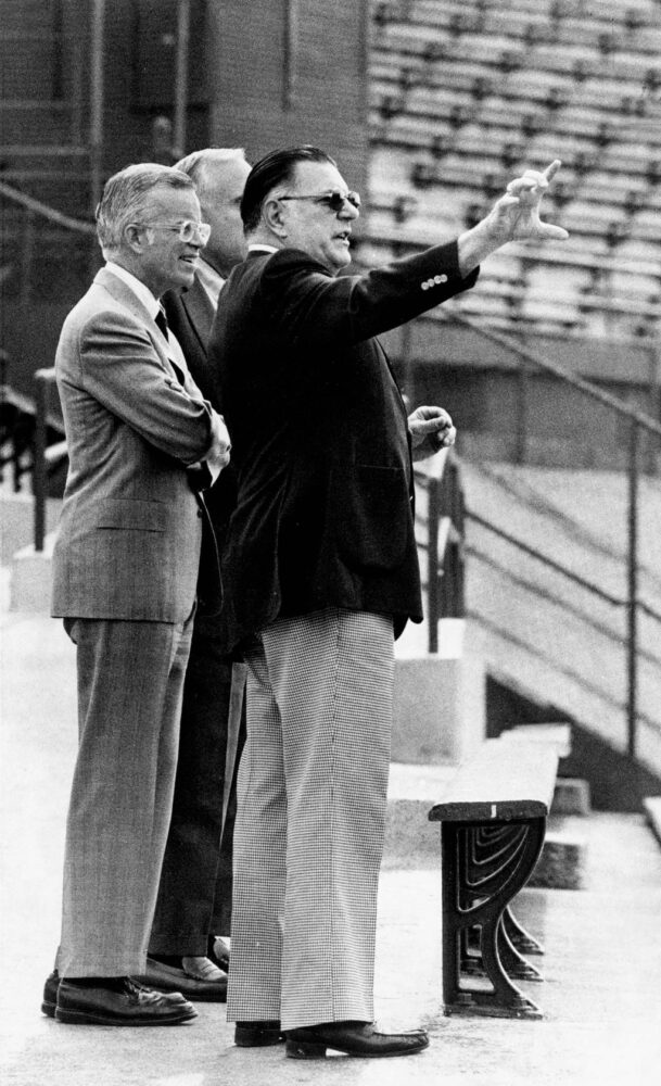 Eldred R. Saltwell, vice president of park operations at Wrigley Field, points out something to Andrew McKenna, new Chairman of the Board of the Cubs, during a guided tour of the park on June 19, 1981. In the background is William Hagenah, president, chief operating officer and treasurer of the team. McKenna will take over once the sale of the Cubs to Tribune Company is approved. 