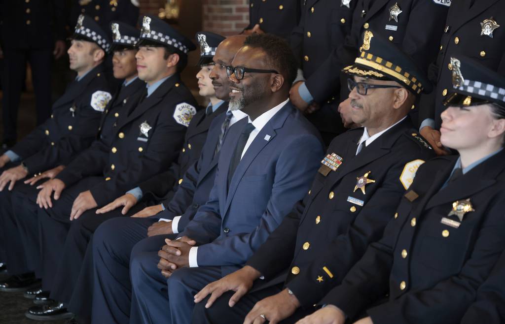 Mayor Brandon Johnson and Interim police Superintendent Fred Waller pose for group photos before the Graduation and Promotion Ceremony for the Chicago Police Department’s new recruits and officers at Navy Pier on June 5, 2023.