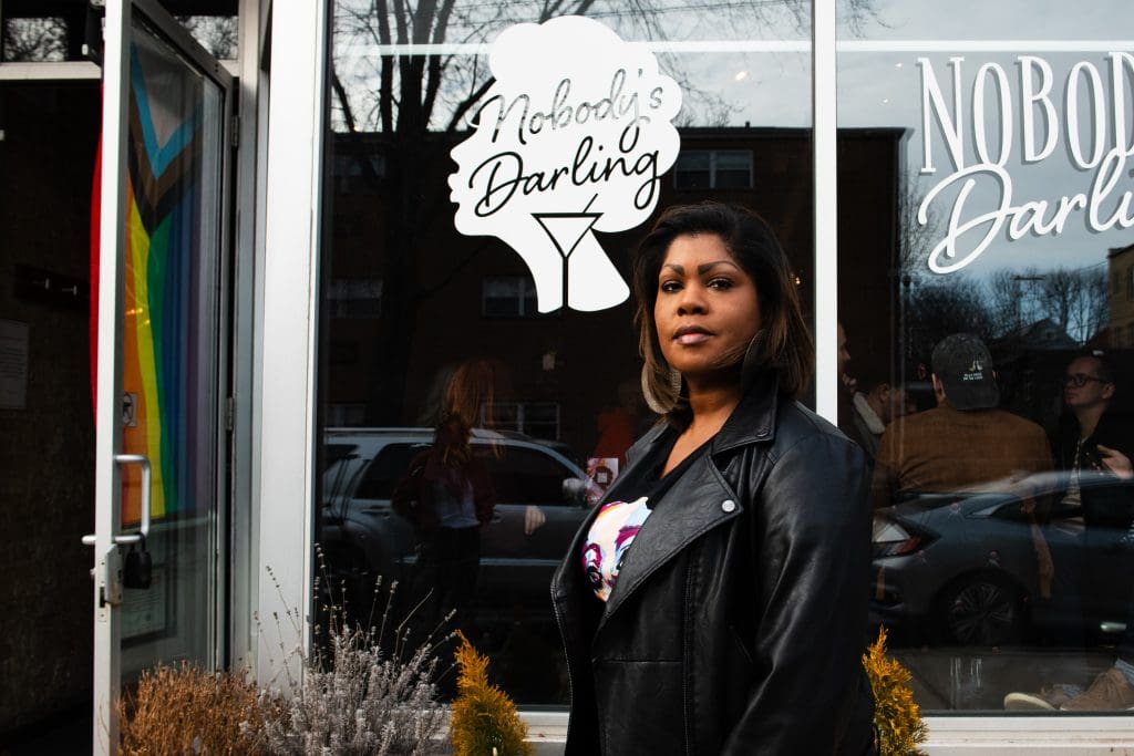 Renauda Riddle, standing outside of Nobody’s Darling, the co-owner of the bar North Side of Chicago in Andersonville. This space is a black women-owned and queer-friendly bar. Photo by Ash Lane for The TRiiBE®