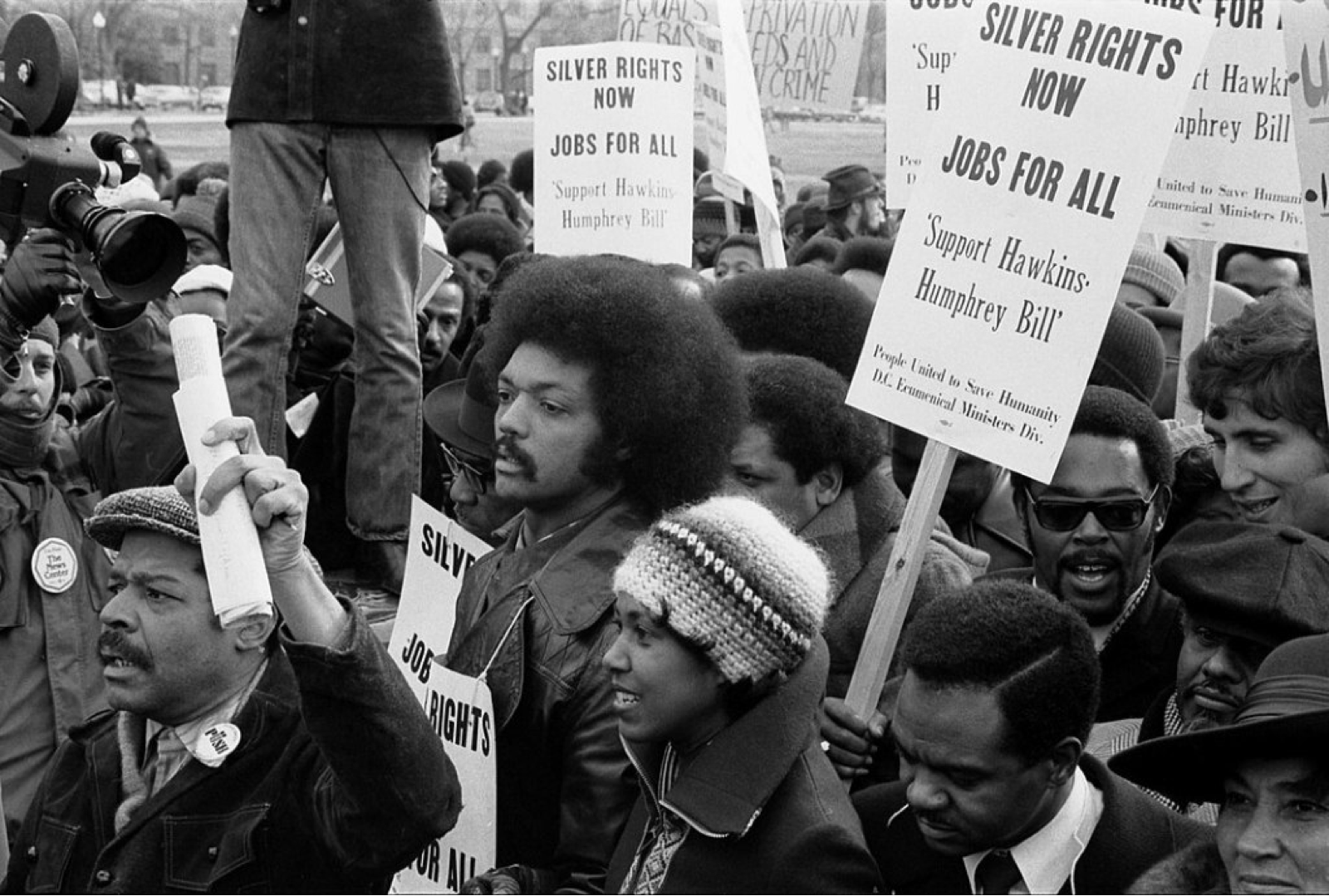 Jesse Jackson surrounded by marchers carrying signs advocating support for the Hawkins-Humphrey Bill for full employment, near the White House, Washington, D.C.