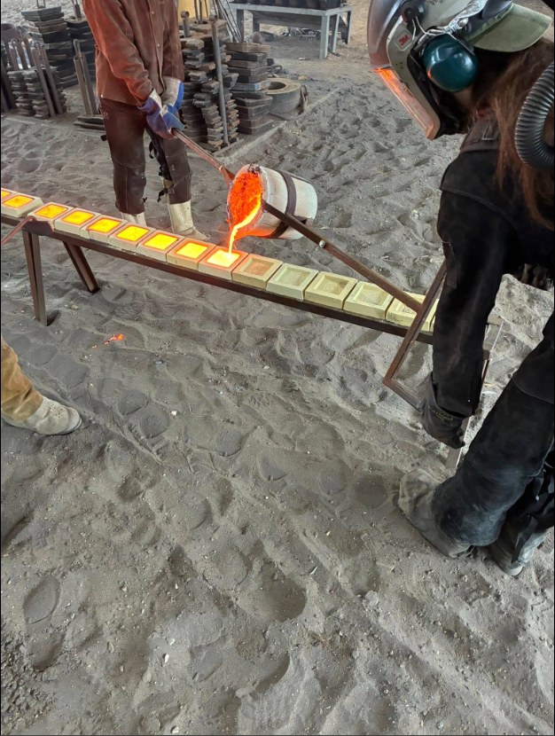 A metal artist pours molten iron during a demonstration for students at Sloss Furnaces.