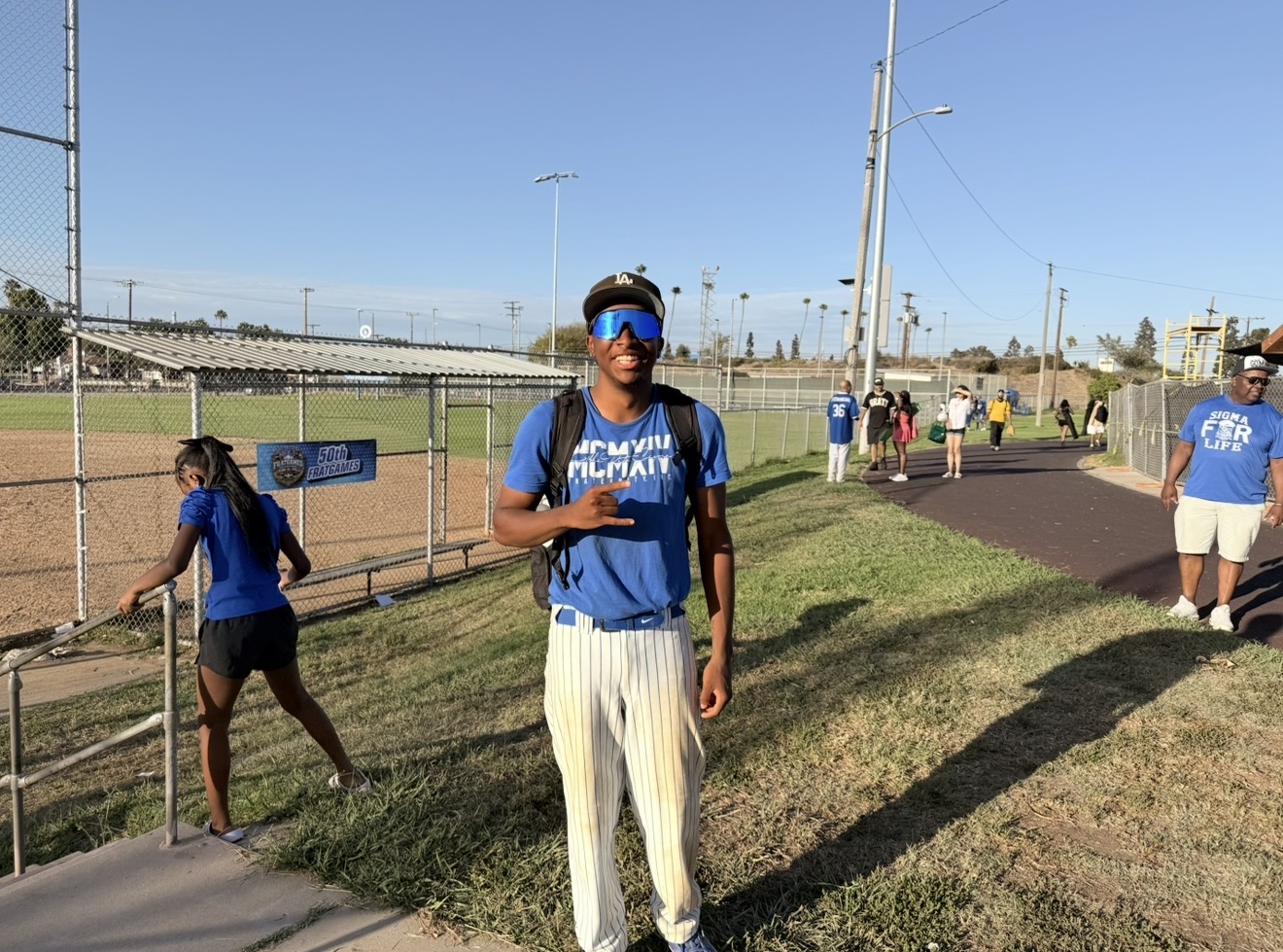 Mason Fowler poses after competing in the Phi Beta Sigma Fraternity, Inc. vs. Alpha Phi Alpha Fraternity, Inc. softball game during Frat Games at Darby Park in Inglewood, Calif., on Saturday, July 25. (Daniele Lawson / L.A. Sentinel)