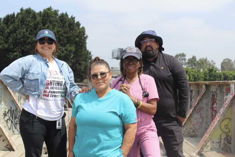Members of St. John’s street medicine team stand along the L.A. River after completing medical care rounds. Photo by Marion Apio