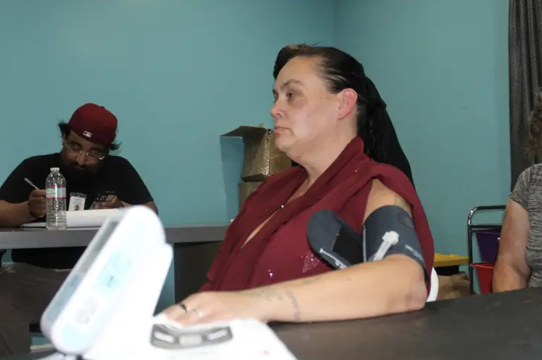 Tanny Hernandez undergoes weekly follow-up care from St. John’s street medicine providers at her downtown transitional housing site. Photo by Marion Apio